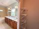 Bathroom with double sink vanity, large mirror, and separate shelving for storage at 625 Chestnut St # D, Atlanta, GA 30354