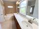 Well-lit bathroom featuring a double sink vanity, large mirror, and tiled tub/shower combo at 625 Chestnut St # D, Atlanta, GA 30354