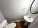 Small bathroom featuring a pedestal sink, toilet, and hardwood flooring at 625 Chestnut St # D, Atlanta, GA 30354