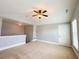 Spacious bedroom with neutral walls, carpet, a ceiling fan and ample natural light at 625 Chestnut St # D, Atlanta, GA 30354