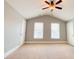 Bedroom with neutral walls and carpet, featuring a ceiling fan and two windows at 625 Chestnut St # D, Atlanta, GA 30354