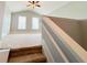 Open bonus room featuring stairs, windows, and a ceiling fan at 625 Chestnut St # D, Atlanta, GA 30354