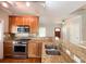 Close-up of a kitchen with granite counters, stainless steel appliances, and wood cabinetry at 625 Chestnut St # D, Atlanta, GA 30354