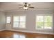 Living room boasts hardwood floors, neutral paint, and two windows plus a glass paneled door at 625 Chestnut St # D, Atlanta, GA 30354
