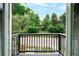 Balcony view overlooking green trees and a quiet residential street at 848 Fox Nw St, Atlanta, GA 30318