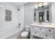 Modern bathroom with tiled walls, decorative accent tiles, a marble vanity, and chrome fixtures at 848 Fox Nw St, Atlanta, GA 30318