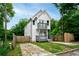 Charming two-story home with a white exterior, gray trim, small balconies, and well-kept lawn at 848 Fox Nw St, Atlanta, GA 30318