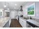 Modern kitchen featuring granite countertops, stainless steel appliances, a kitchen island, and hardwood floors at 848 Fox Nw St, Atlanta, GA 30318