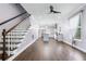 Open-concept living room and kitchen area, featuring hardwood floors, modern lighting, and a staircase at 848 Fox Nw St, Atlanta, GA 30318