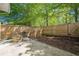 Fenced backyard including a stone fire pit and planting area, great for outdoor relaxation and entertainment at 9155 Nesbit Ferry Rd # 65, Alpharetta, GA 30022