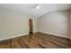 Bedroom featuring a ceiling fan, hardwood floors, neutral walls, and a large window at 9155 Nesbit Ferry Rd # 65, Alpharetta, GA 30022