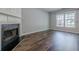 Bright living room with hardwood floors, fireplace, and large window allowing plenty of natural light at 9155 Nesbit Ferry Rd # 65, Alpharetta, GA 30022