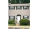 Charming townhome with three windows and front door with dark shutters and greenery at 4701 Flat Shoals Rd # 41-F, Union City, GA 30291