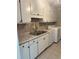 Kitchen featuring white cabinets, stainless steel sink and modern faucet, plus a washing machine at 4701 Flat Shoals Rd # 41-F, Union City, GA 30291