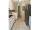 Kitchen featuring white cabinets, tile floor, appliances, and washer and dryer hook ups at 4701 Flat Shoals Rd # 41-F, Union City, GA 30291