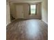 Living room with wood laminate flooring, a window, and neutral walls at 4701 Flat Shoals Rd # 41-F, Union City, GA 30291