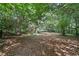 Large, wooded backyard offering privacy and a peaceful view at 7635 Wynfield Dr, Cumming, GA 30040