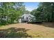 Backyard view showing the deck, mature trees, and lush lawn of the property at 7635 Wynfield Dr, Cumming, GA 30040