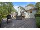 Backyard deck view with grill station and mature landscaping, great for entertaining outdoors at 7635 Wynfield Dr, Cumming, GA 30040