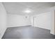 Spacious unfinished basement featuring sealed concrete floors and natural light through window at 7635 Wynfield Dr, Cumming, GA 30040