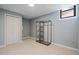 Finished basement with carpet, closet and storage rack, offering space and organization at 7635 Wynfield Dr, Cumming, GA 30040