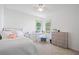 This bedroom features a large window, light-colored walls, neutral carpet, and ample space at 7635 Wynfield Dr, Cumming, GA 30040