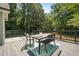 Outdoor dining set on spacious deck offers views of a lush, green backyard at 7635 Wynfield Dr, Cumming, GA 30040