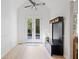 The entryway features double doors to backyard, white walls, light floor and a built-in bench with coat hooks at 7635 Wynfield Dr, Cumming, GA 30040