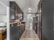 Efficient galley kitchen features dark cabinets, granite countertops, and modern flooring at 7635 Wynfield Dr, Cumming, GA 30040