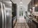 Bright kitchen features modern stainless steel appliances, granite countertops, and access to the backyard through glass doors at 7635 Wynfield Dr, Cumming, GA 30040