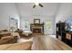 Bright living room with a stone fireplace, vaulted ceilings, and natural light at 7635 Wynfield Dr, Cumming, GA 30040