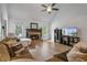 Bright living room with a stone fireplace, vaulted ceilings, and natural light at 7635 Wynfield Dr, Cumming, GA 30040