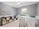 Bright office space features a large window, modern desk, shelving unit and neutral decor at 7635 Wynfield Dr, Cumming, GA 30040