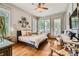 Sunlit bedroom featuring hardwood floors, large windows, and comfortable sitting area at 790 Lakeview Ne Ave, Atlanta, GA 30308