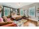 Cozy bedroom featuring a stylish bed, hardwood floors, and ample natural light at 790 Lakeview Ne Ave, Atlanta, GA 30308