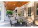 Charming covered patio featuring an outdoor seating area, fireplace, and a beautiful brick wall at 790 Lakeview Ne Ave, Atlanta, GA 30308
