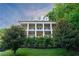 Stately three-story home featuring white columns, balconies, dormer windows, and lush landscaping at 790 Lakeview Ne Ave, Atlanta, GA 30308