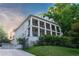 Elegant three-story home with white brick, columns, balconies, driveway, and manicured lawn at 790 Lakeview Ne Ave, Atlanta, GA 30308