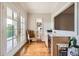 Hallway features french doors leading to a balcony, a built-in bar area, and hardwood floors at 790 Lakeview Ne Ave, Atlanta, GA 30308