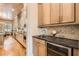 Kitchenette featuring stone countertops, wooden cabinets and backsplash, as well as a wine cooler at 790 Lakeview Ne Ave, Atlanta, GA 30308