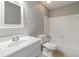 Bathroom features a white vanity, a framed mirror, a toilet, and a shower-tub combo with white tiling at 1353 Litchfield Ct, Snellville, GA 30078