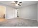 Spacious bedroom with plush carpet, fresh paint, and access to an ensuite bathroom and walk-in closet at 1353 Litchfield Ct, Snellville, GA 30078