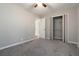 Bedroom features plush carpet, fresh paint, a ceiling fan, and a large closet with shelving at 1353 Litchfield Ct, Snellville, GA 30078