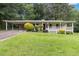 Charming one-story home with a carport, covered porch, and a well-manicured front yard at 1353 Litchfield Ct, Snellville, GA 30078