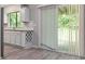 Well-lit kitchen features modern cabinets, tiled backsplash, and sliding door access to the deck at 1353 Litchfield Ct, Snellville, GA 30078