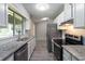 Modern kitchen features stainless steel appliances, granite countertops, white cabinets, and tile backsplash at 1353 Litchfield Ct, Snellville, GA 30078