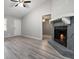 Inviting living room features a fireplace, ceiling fan, modern gray plank flooring, and open floorplan at 1353 Litchfield Ct, Snellville, GA 30078