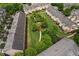 Aerial view of neighborhood with townhomes surrounding community green space at 1973 Cobblestone Cir, Brookhaven, GA 30319
