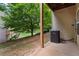 Back porch overlooking a grassy area with mature trees and wooden support beams at 1973 Cobblestone Cir, Brookhaven, GA 30319