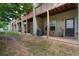 Backyard view of townhome patios with AC units and grassy area behind the building at 1973 Cobblestone Cir, Brookhaven, GA 30319